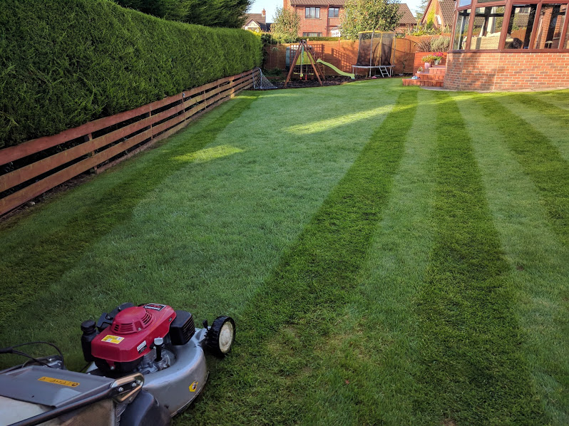 Lawn mowing service from Premier Lawns leaving a neatly cut lawn.