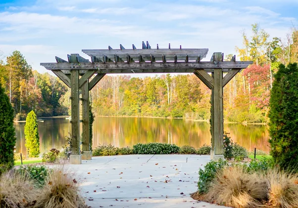 Wooden pergola acting as wedding reception or event space.