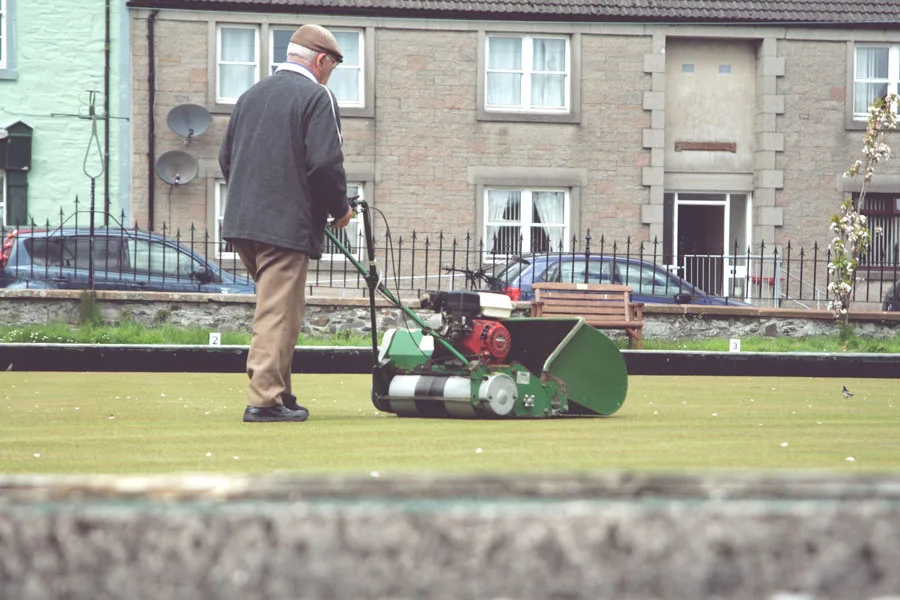 Cylinder lawn mower being used to maintain bowling green