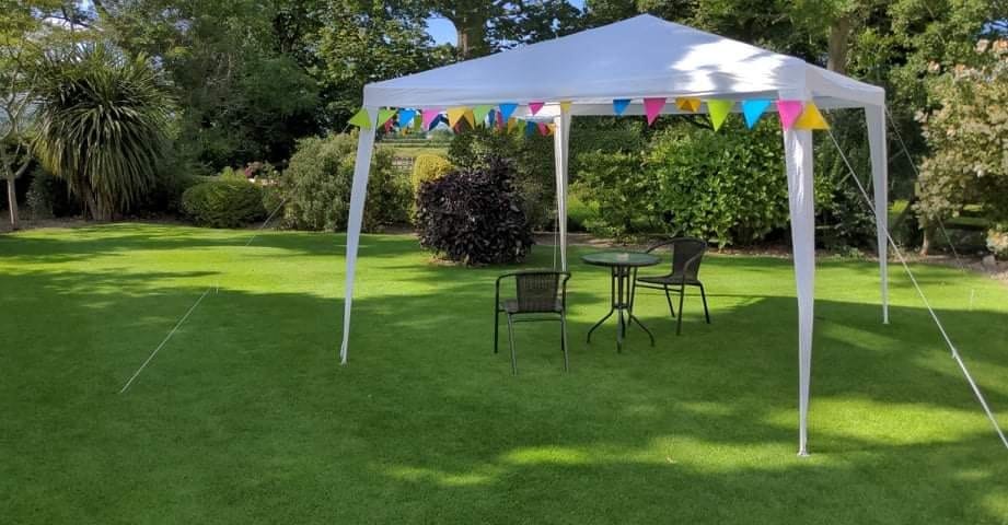 July lawn with pergola and seats