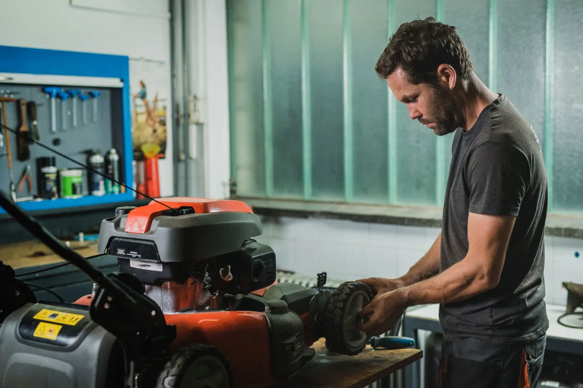 servicing a lawnmower as part of a November lawn care program