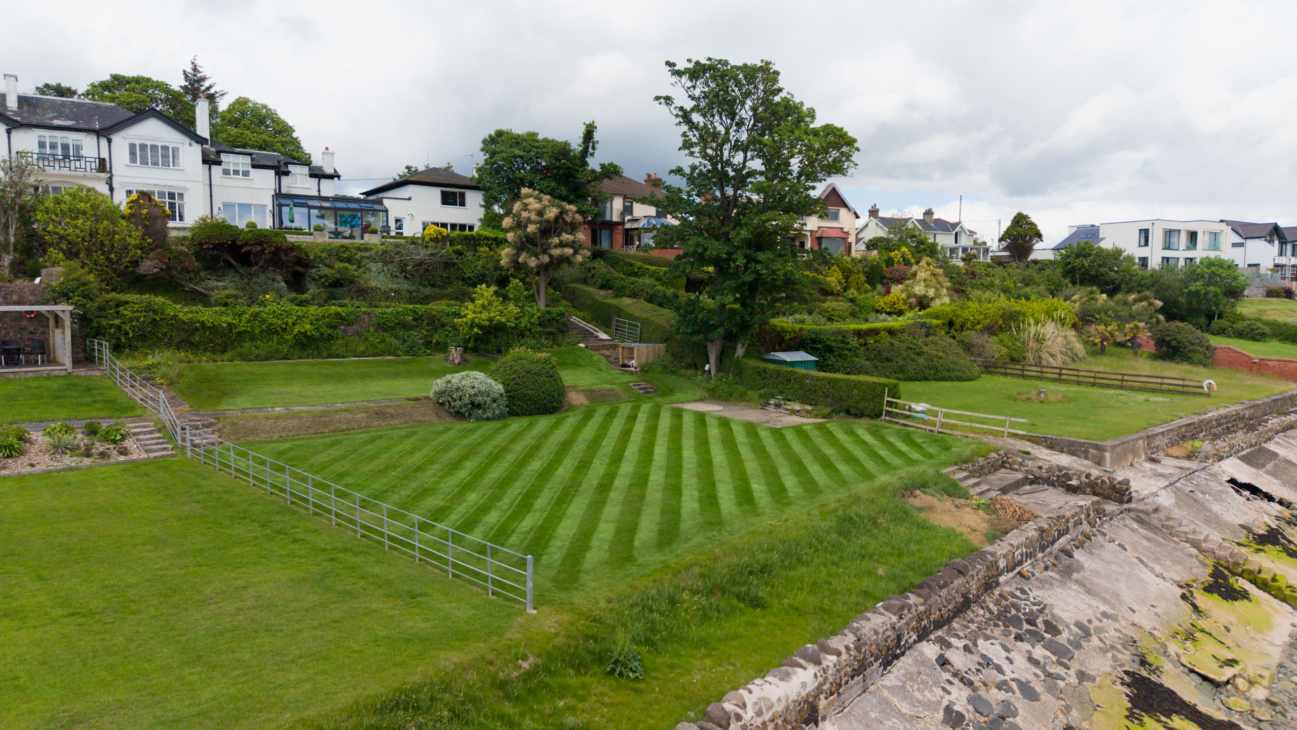 Aerial view of a striped lawn in a sloping garden