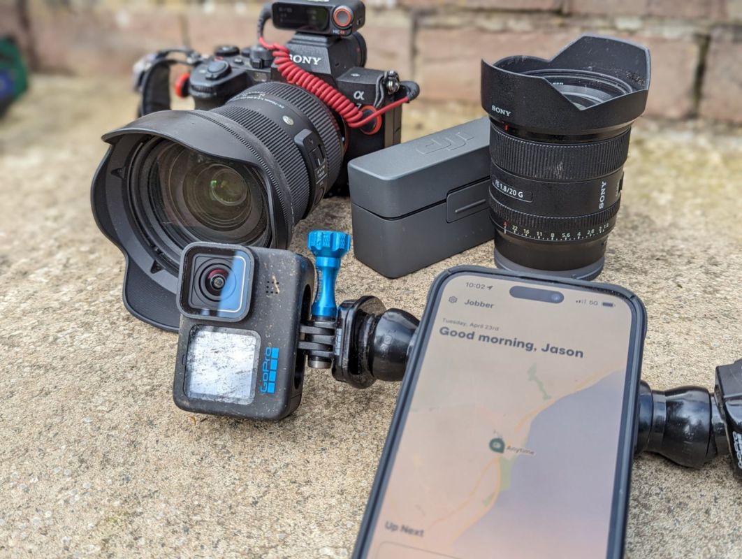 Premier Lawns filming kit: a Sony camera, GoPro, wireless mic and a phone open on Jobber